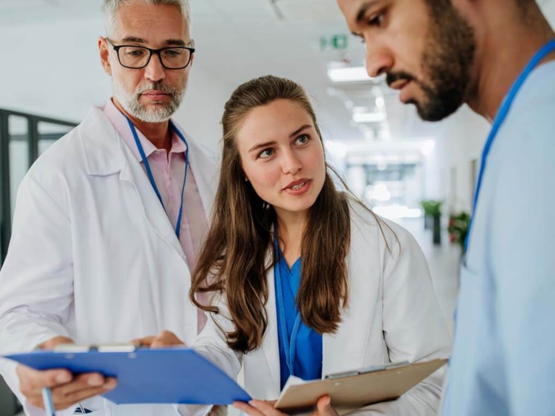 Group of doctors reviewing chart